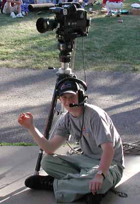 Jeremy sits in front of his camera wearing a headset.