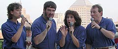 Diane, Glen, Karen, and Kirk sing, against the backdrop of the St. Paul skyline.