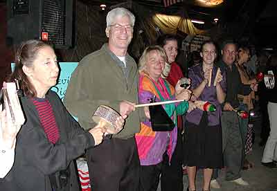 Volunteers play cabasa, cow bell, and other Latin percussion instruments.