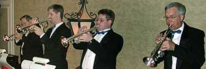 The trumpet section, dressed in tuxes and black ties, plays a chorus of "Alley Cat".
