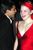 A lady in red dances the cha-cha.