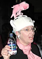 Wearing a "one fish" hat, a dancer offers us a drink of water.