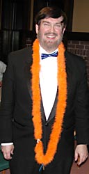 Glen wears an orange waist-length lei with the key at the bottom.