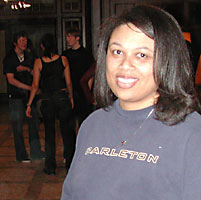 Robin smiles at the camera while students mill around after the dance.