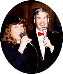 Mary Lou and Glen sing a duet facing the camera.