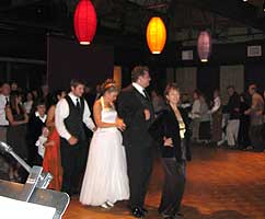 Dancers form a line on the wooden dance floor.