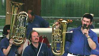Carin and Glen hold the tuba and euphonium in the air.  Bigger picture is 61K.