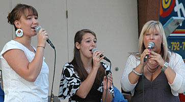 Val, Carly, and Laura sing at Central Park