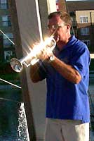 Sunlight reflects off Dan's trumpet.