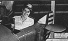 Pat Campion tries out the WW II Link Flight Trainer