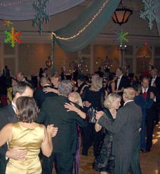 Wintery drapes and giant colorful snowflakes hang over the dancers.