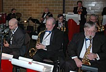 Len, Glen, and Dan play saxes, with Dave, Mike, Rich, Jeff, and Mike in the background.