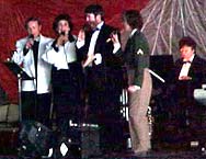 The Rosetones sing as Ann plays the piano.