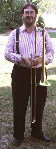 Glen wears red-and-white striped shirt with blue suspenders and black trousers.