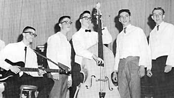 The group pretends to sing on stage wearing the dance band's white waiter's jackets.
