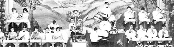 The brass are at the right, saxes and flutes at left, and rhythm section in the middle.