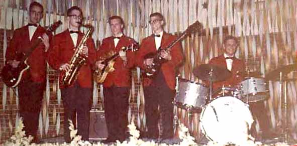 The Crusaders pose in red sport coats with black bow ties.