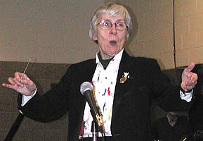 Carol Jensen conducts the St. Anthony Civic Orchestra and audience while singing along.