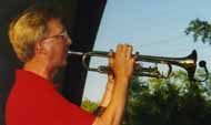 In red Roseville Big Band summer shirt, Bob plays trumpet with a wireless mic attached to the bell.