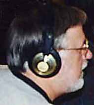 Dan listens through headphones.