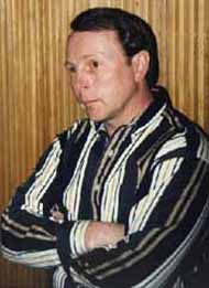 With folded arms, Kirk concentrates in the Studio M control room.