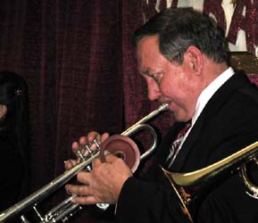 Bob plays trumpet, holding the plunger in his left hand.