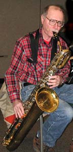 Keith plays baritone sax at a rehearsal.