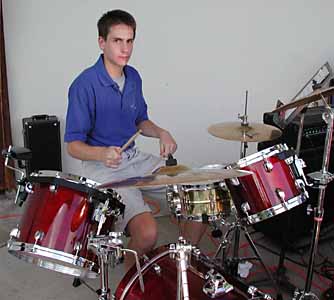 David poses for the camera at his drum set.