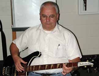 Larry plays his four-string Rickenbacker bass.