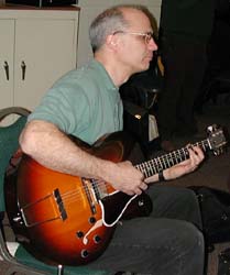 Jim plays his Gibson archtop guitar.