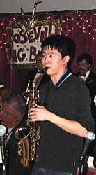Will solos with the Roseville Big Band sign in the background.