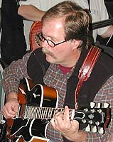 Fred plays a barre chord.