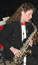 Leslie plays alto while seated.