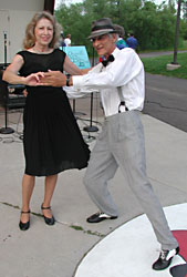 Larry taps the concert rose with his left foot while Betty gets ready to swing.