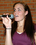 Dani gazes skyward while singing.
