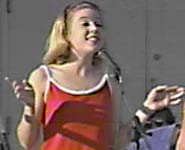 Sarah gestures with both hands.