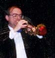 Jim Chamberlain plays trumpet with a red straight mute.