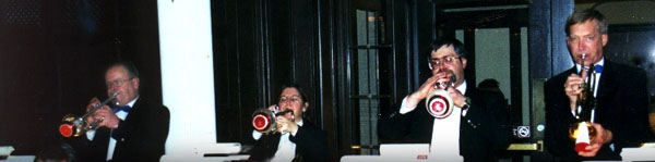 The trumpet section plays in front of the double doors to the Great Room.